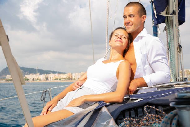 couple sailing on yacht in calm during romantic summer vacation